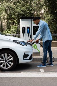 full-shot-man-charging-electric-car