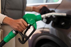view-woman-with-car-gas-station_11zon